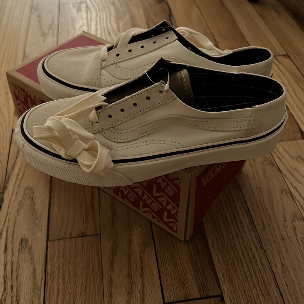 Vans (women’s size 6.5) white mules with checkered insole.